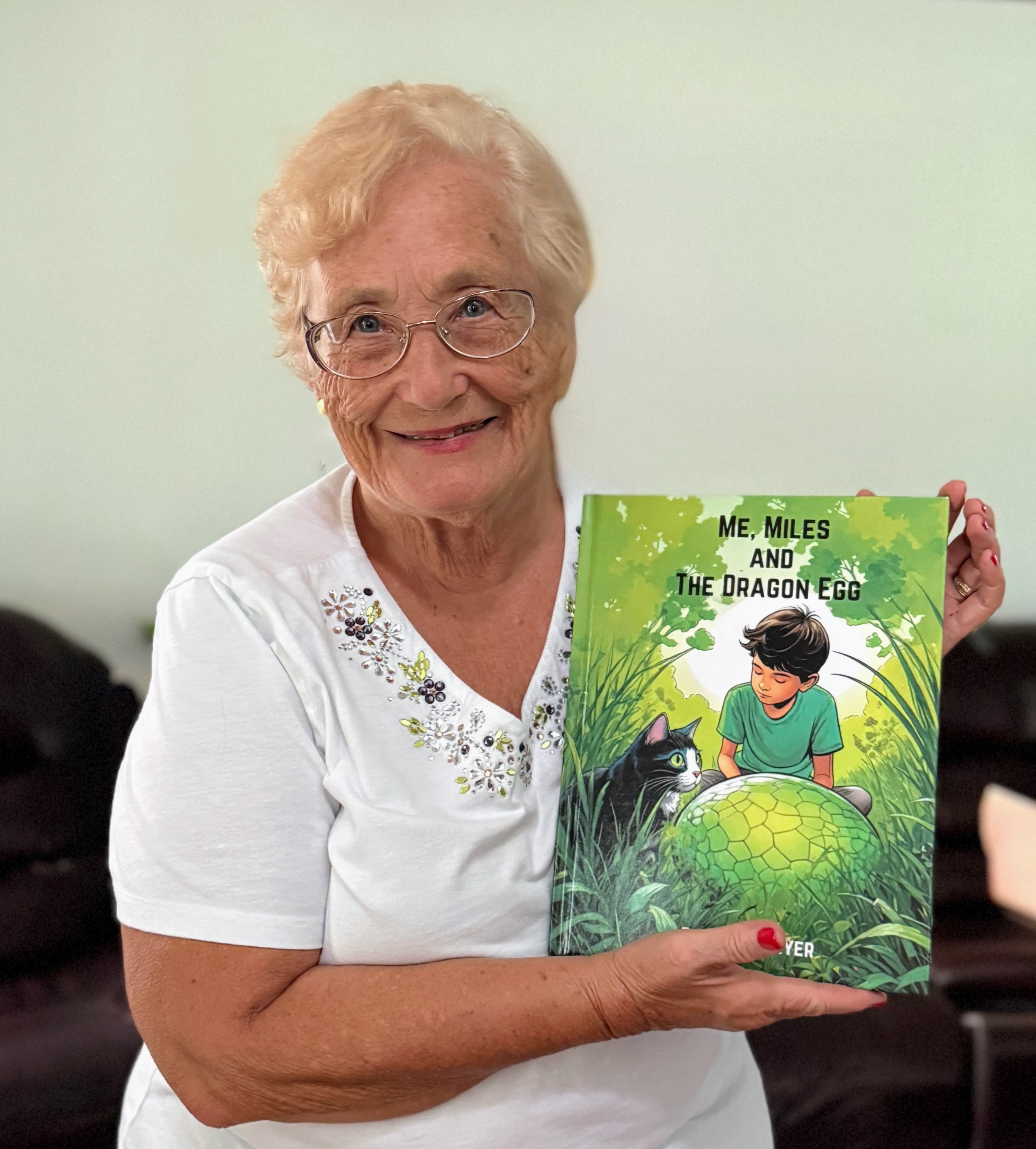 Donna L. Beyer holding a My Dragon book